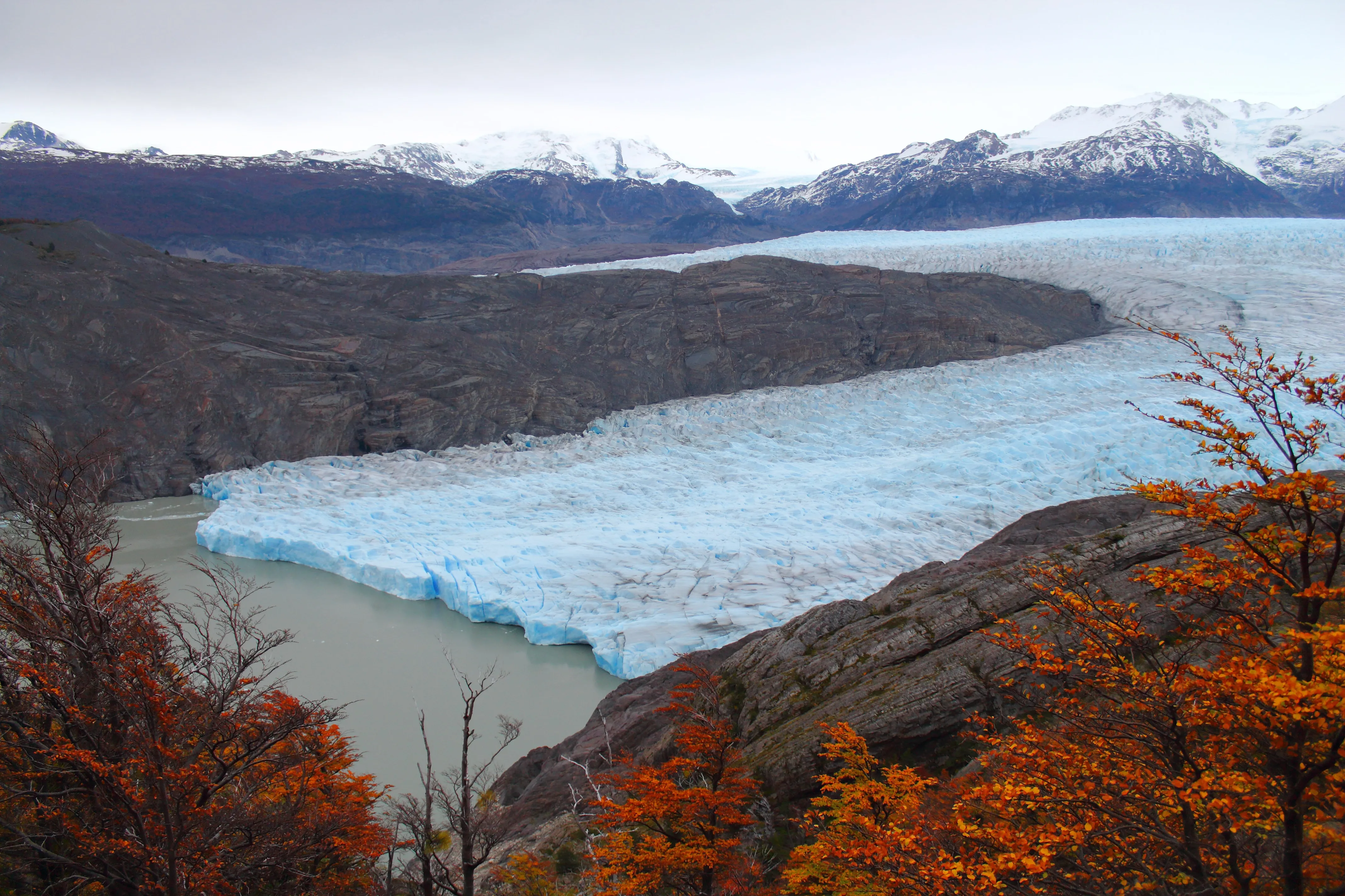 image of a glacier surrounded by mountains